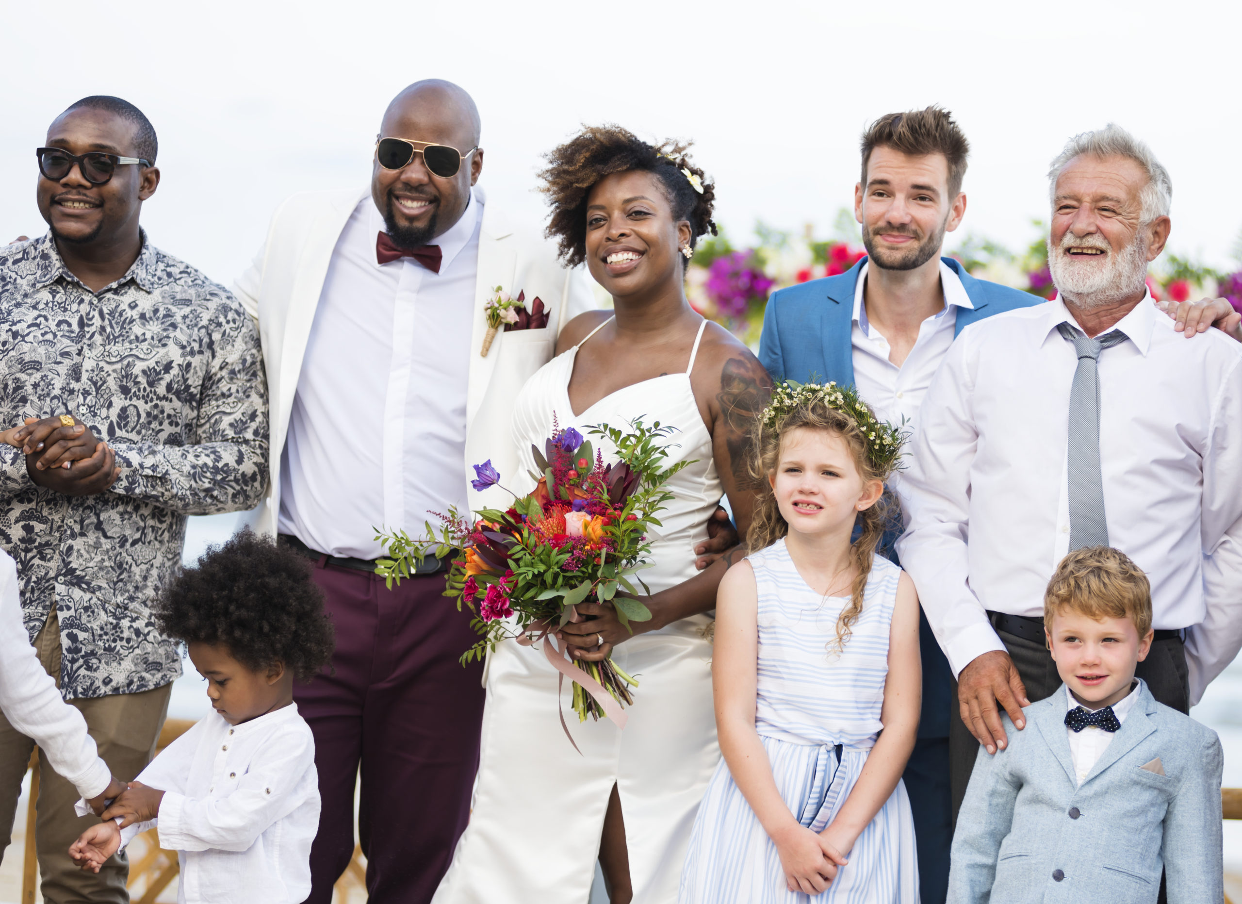 Happy bride and groom in a wedding ceremony at a tropical island Family members celebrating destination wedding beach talking
